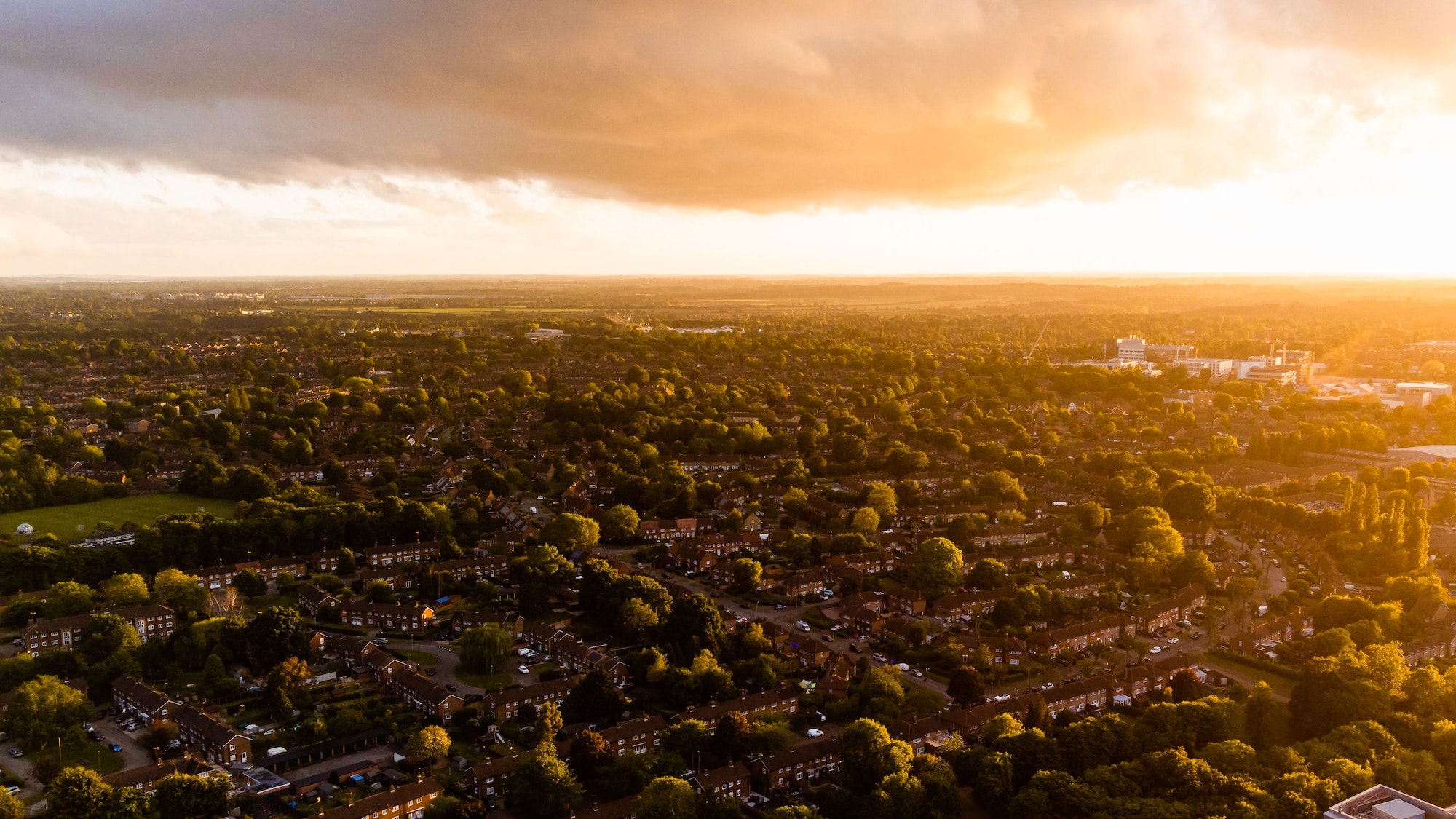 Aerial drone shot of Welwyn Garden City town in Hertfordshire, England at sunset