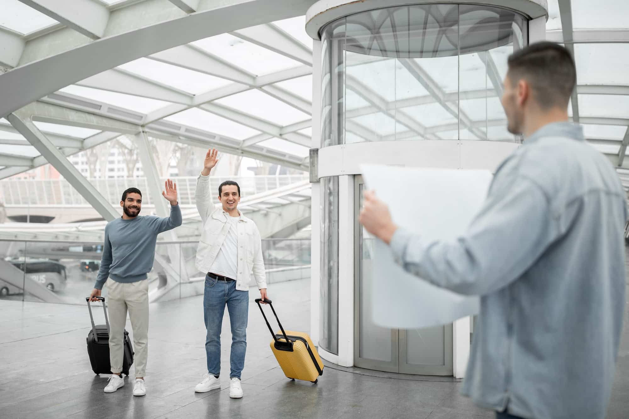 Tourists Men Waving To Meet And Greet Guy At Airport